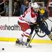 Michigan sophomore right wingman Zach Hyman makes contact with Miami defenseman Joe Hartman on Saturday, March 23. Daniel Brenner I AnnArbor.com